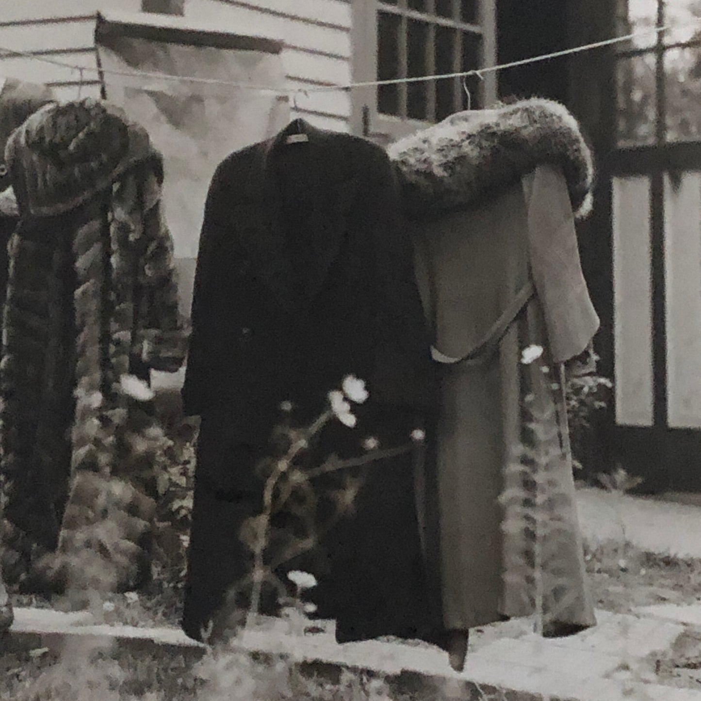 Press Photo Photograph Woman with Winter Coats on Clothesline keystone Underwood