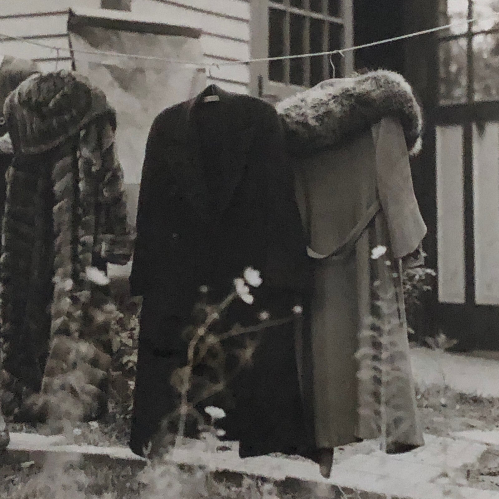 Press Photo Photograph Woman with Winter Coats on Clothesline keystone Underwood