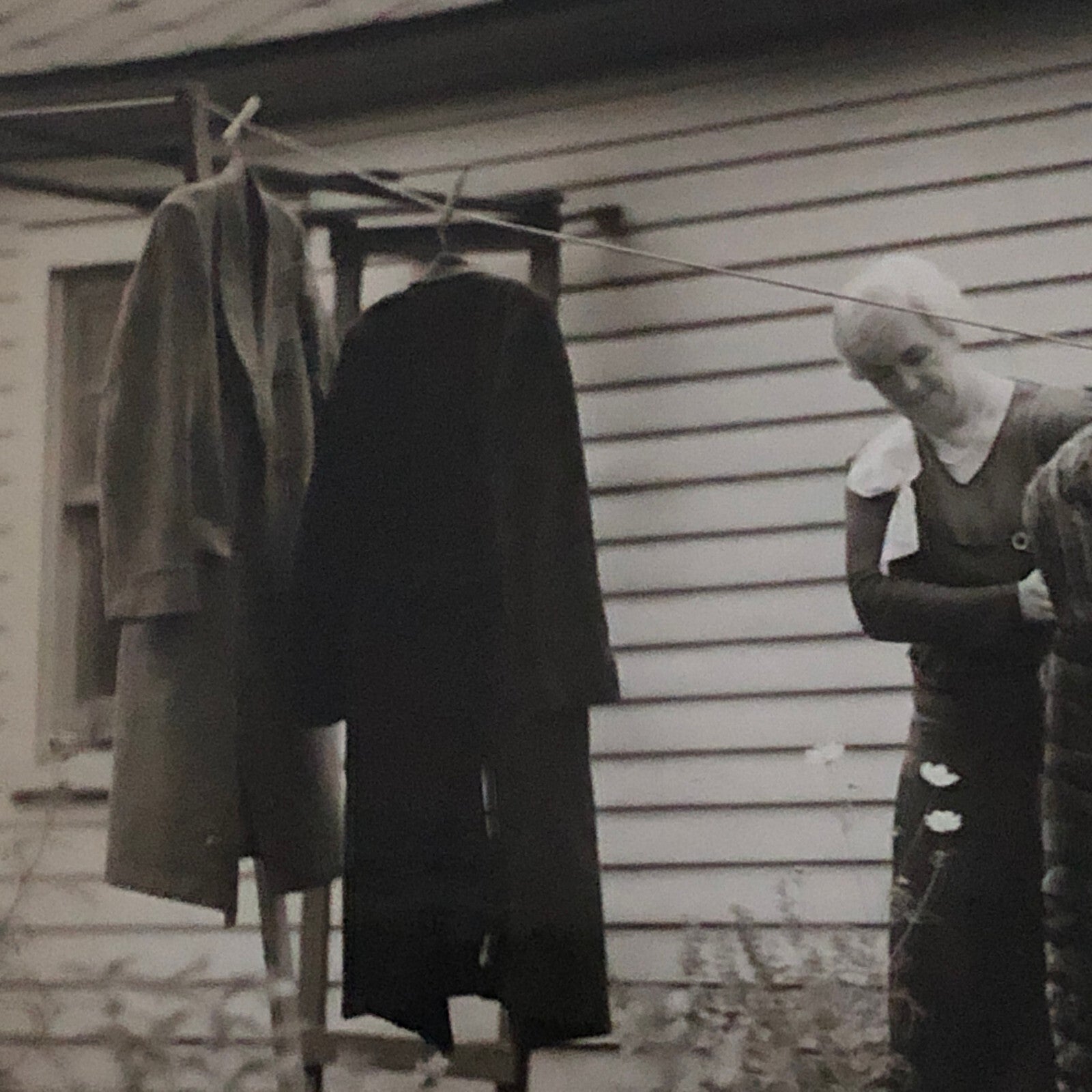 Press Photo Photograph Woman with Winter Coats on Clothesline keystone Underwood