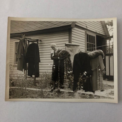 Press Photo Photograph Woman with Winter Coats on Clothesline keystone Underwood